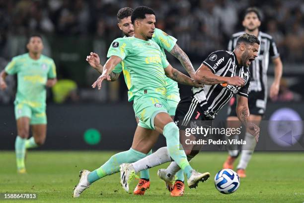 Murilo of Palmeiras challenges for the ball with Hulk of Atletico Mineiro during the Copa CONMEBOL Libertadores round of 16 first leg match between...