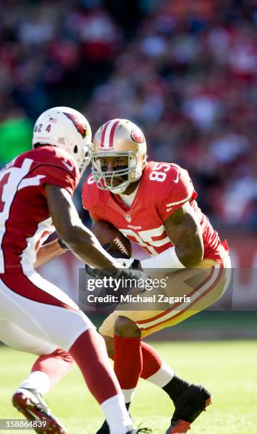 Vernon Davis of the San Francisco 49ers gets tackled by Adrian Wilson of the Arizona Cardinals after making a reception during the game at...