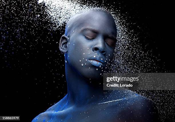 close up of black male model with blue make-up - black makeup stockfoto's en -beelden