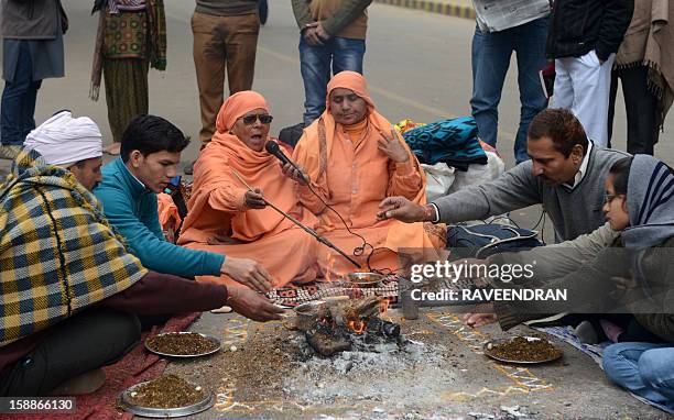 Indian holy women and demonstrators perform a prayer ritual in memory of a gangrape victim in New Delhi on January 2, 2013. The family of an Indian...