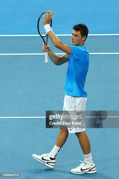 Bernard Tomic of Australia celebrates winning his singles match against Novak Djokovic of Serbia during day five of the Hopman Cup at Perth Arena on...