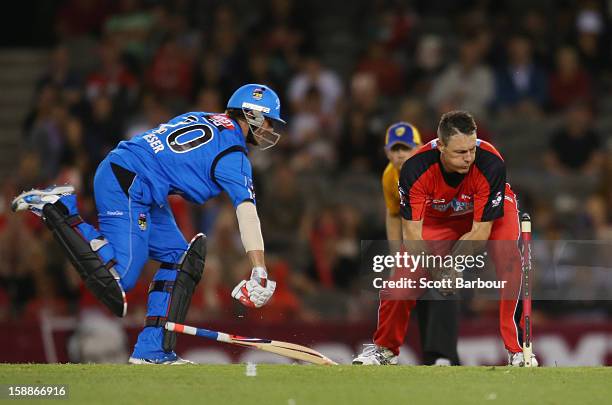 Darren Pattinson of the Renegades attempts to run out Michael Neser of the Strikers during the Big Bash League match between the Melbourne Renegades...