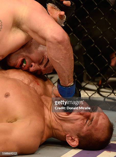 Cain Velasquez punches Junior dos Santos during their heavyweight championship fight at UFC 155 on December 29, 2012 at MGM Grand Garden Arena in Las...