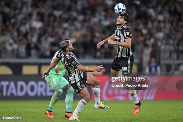 Igor Rabello of Atletico Mineiro heads the ball while observed by teammate Hulk and Zé Rafael of Palmeiras during the Copa CONMEBOL Libertadores...