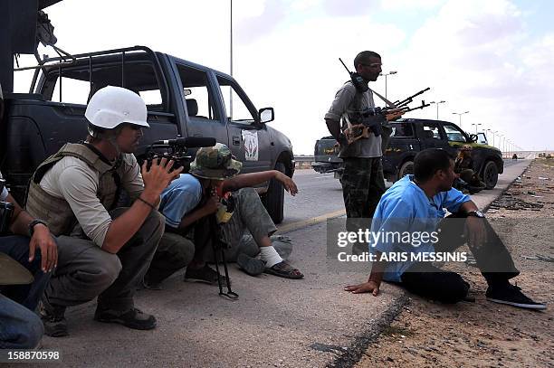 Photo taken on September 29, 2011 shows US freelance reporter James Foley on the highway between the airport and the West Gate of Sirte, Libya. Foley...