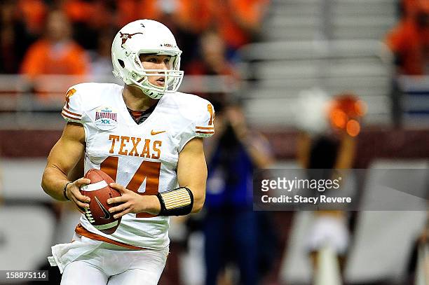 David Ash of the University of Texas Longhorns looks for an open receiver against the Oregon State Beavers during the Valero Alamo Bowl at the...