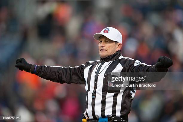 Referee Ed Hochuli signals during a game between the Denver Broncos and the Kansas City Chiefs at Sports Authority Field at Mile High on December 30,...