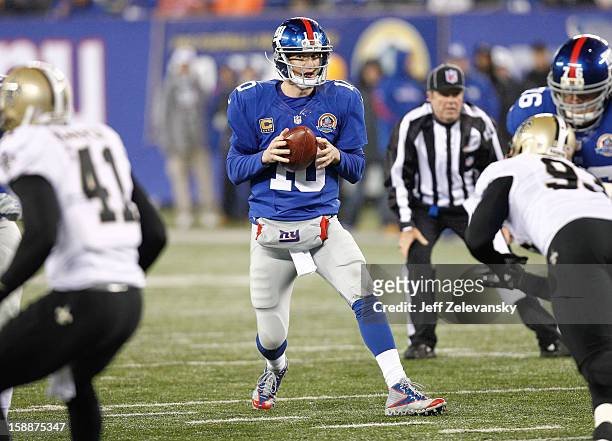 Eli Manning of the New York Giants looks for a no pen man against the New Orleans Saints during their game at MetLife Stadium on December 9, 2012 in...
