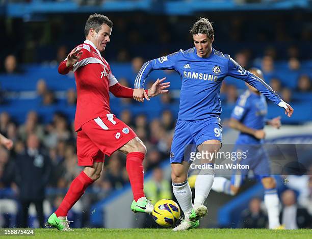 Ryan Nelsen of Queens Park Rangers and Fernando Torres of Chelsea tussle for the ball during the Barclays Premier League match between Chelsea and...