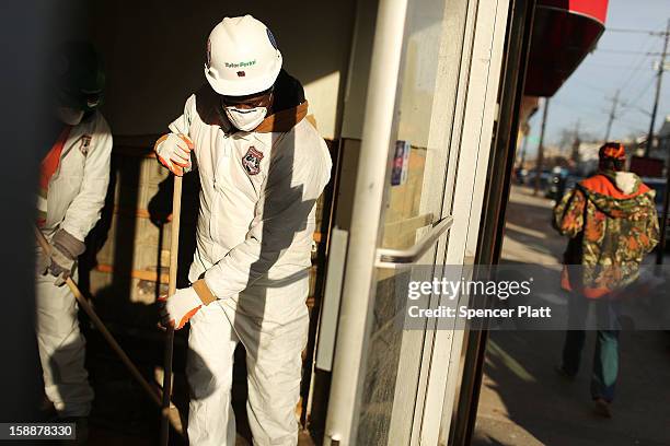 Clean up continues at damaged and destroyed homes and businesses after Superstorm Sandy in the Rockaways on January 2, 2013 in the Queens borough of...