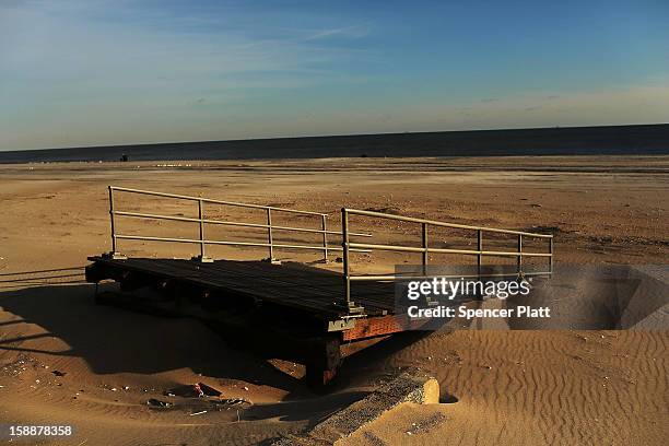 The remains of part of the boardwalk lie along the beach in the Rockaways on January 2, 2013 in the Queens borough of New York City. Criticism,...