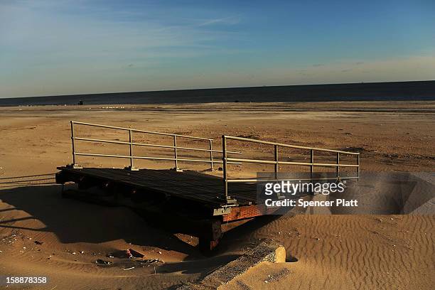 The remains of part of the boardwalk lie along the beach in the Rockaways on January 2, 2013 in the Queens borough of New York City. Criticism,...