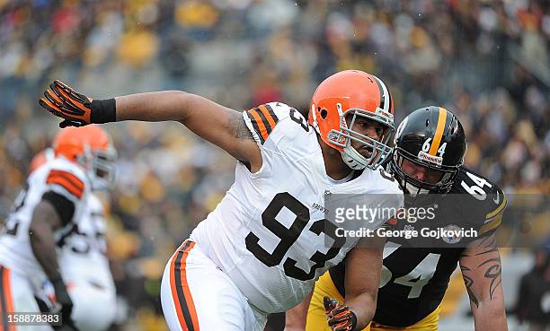 Defensive lineman John Hughes of the Cleveland Browns pursues the play against offensive lineman Doug Legursky of the Pittsburgh Steelers during a...