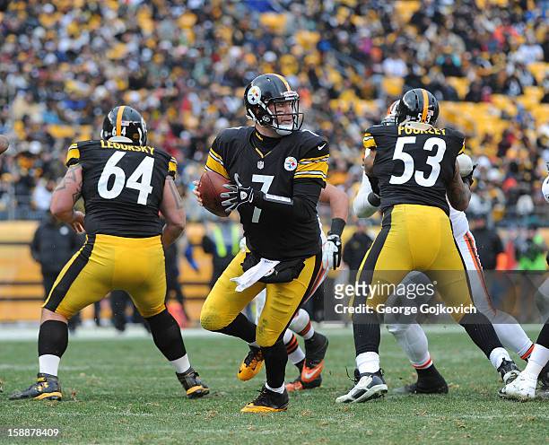 Quarterback Ben Roethlisberger of the Pittsburgh Steelers looks to pass behind the blocking of offensive linemen Doug Legursky and Maurkice Pouncey...
