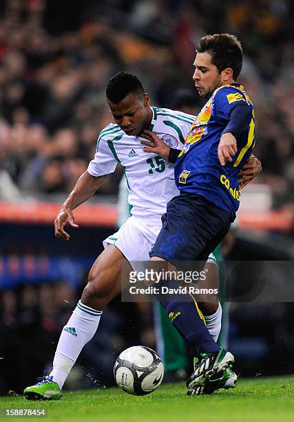 Uche Ikechukwu of Nigeria duels for the ball with Jordi Alba of Catalonia during a friendly match between Catalonia and Nigeria at Cornella-El Prat...