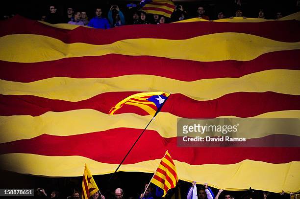 Catalonian pro-indepence flag flies over a Catalan flag prior to a friendly match between Catalonia and Nigeria at Cornella-El Prat Stadium on...