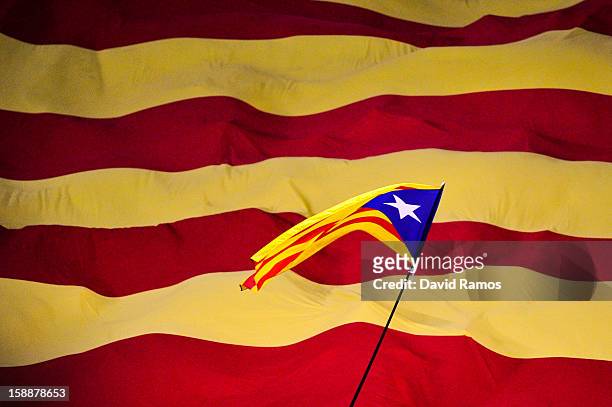 Catalonian pro-indepence flag flies overa Catalan flag prior to a friendly match between Catalonia and Nigeria at Cornella-El Prat Stadium on January...