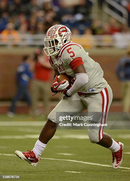 Antonio Andrews of the Western Kentucky University Hilltoppers runs with the football during the Little Caesars Pizza Bowl against the Central...