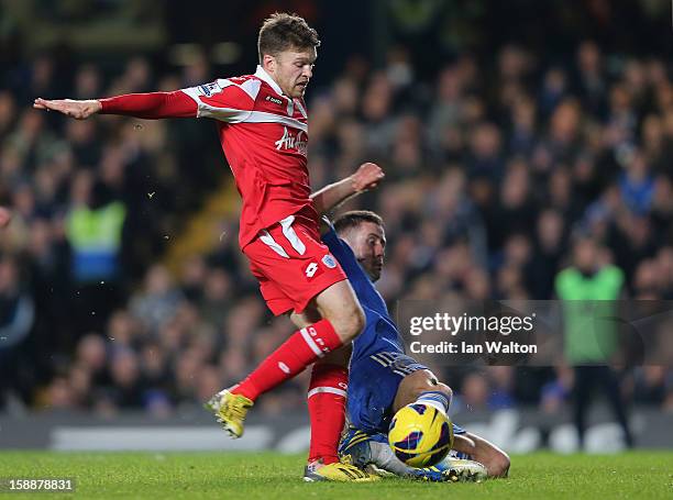 Jamie Mackie of Queens Park Rangers and Gary Cahill of Chelsea battle for the ball during the Barclays Premier League match between Chelsea and...