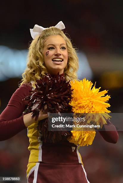 Central Michigan University Chippewas cheerleader looks on during the Little Caesars Pizza Bowl against the Western Kentucky University Hilltoppers...