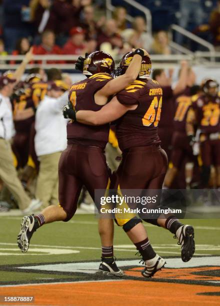 Ryan Radcliff and Andy Phillips of the Central Michigan University Chippewas celebrate a touchdown during the Little Caesars Pizza Bowl against the...