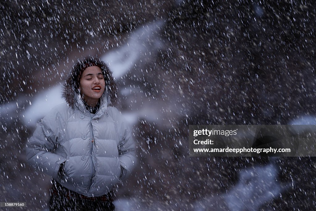 Girl enjoying snowfall