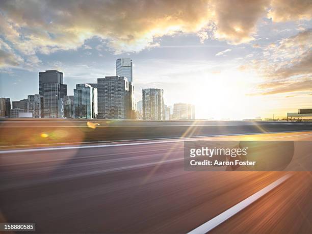 inner city road in motion - melbourne skyline stock-fotos und bilder