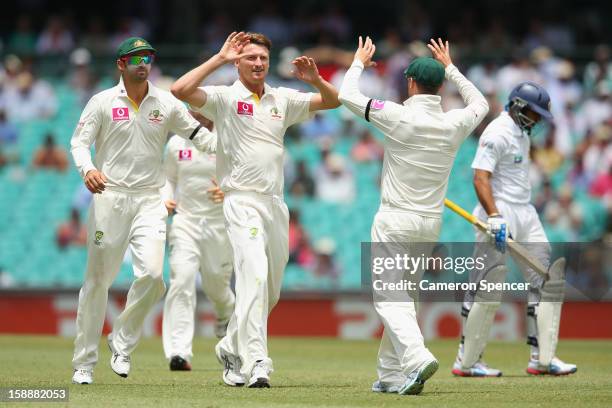 Jackson Bird of Australia celebrates with team mates after dismissing Tillakaratne Dilshan of Sri Lanka during day one of the Third Test match...