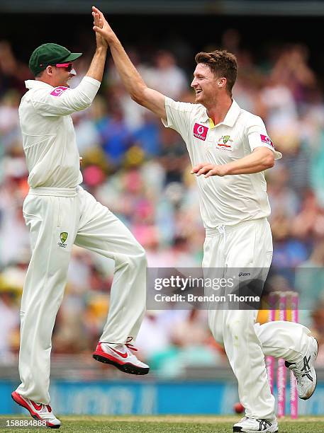 Jackson Bird of Australia celebrates with team mate Michael Hussey after claiming the wicket of Tillakaratne Dilshan of Sri Lanka during day one of...