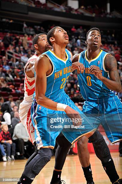 Marcus Morris of the Houston Rockets guards Anthony Davis and Al-Farouq Aminu of the New Orleans Hornets battle for the rebound on January 2, 2013 at...