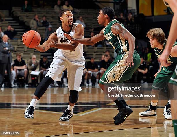 Kedren Johnson of the Vanderbilt Commodores dribbles toward Brandon Britt of William & Mary at Memorial Gym on January 2, 2013 in Nashville,...