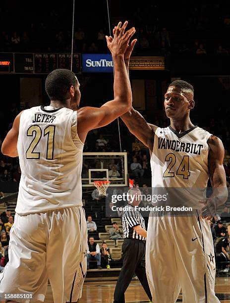 Sheldon Jeter of the Vanderbilt Commodores high fives teammate Dai-Jon Parker during a game against William & Mary at Memorial Gym on January 2, 2013...