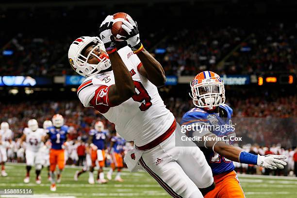 DeVante Parker of the Louisville Cardinals catches a second quarter touchdown pass over Loucheiz Purifoy of the Florida Gators during the Allstate...