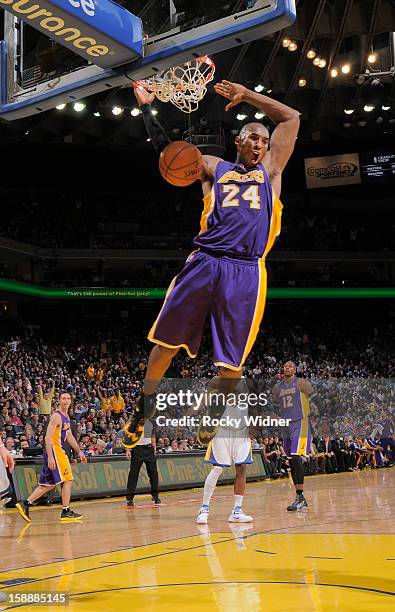 Kobe Bryant of the Los Angeles Lakers dunks the ball in against the Golden State Warriors on December 22, 2012 at Oracle Arena in Oakland,...