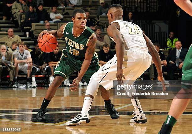 Brandon Britt of William & Mary dribbles against Dai-Jon Parker of the Vanderbilt Commodores at Memorial Gym on January 2, 2013 in Nashville,...