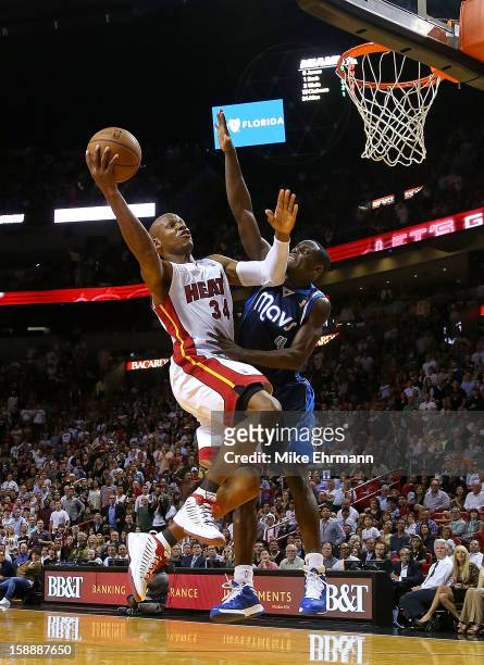Ray Allen of the Miami Heat shoots over Darren Collison of the Dallas Mavericks during a game at American Airlines Arena on January 2, 2013 in Miami,...