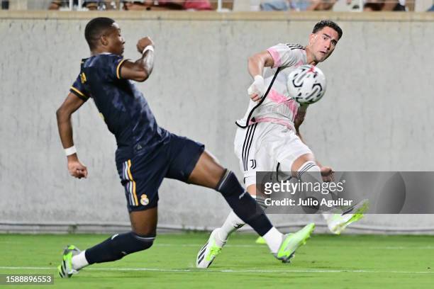 Dušan Vlahović of Juventus passes the ball against David Alaba of Real Madrid in the second half of a pre-season friendly match at Camping World...