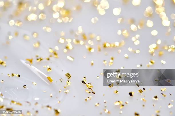the texture of the serum with 24k golden particles close-up. abstract background. - gel pack stock pictures, royalty-free photos & images
