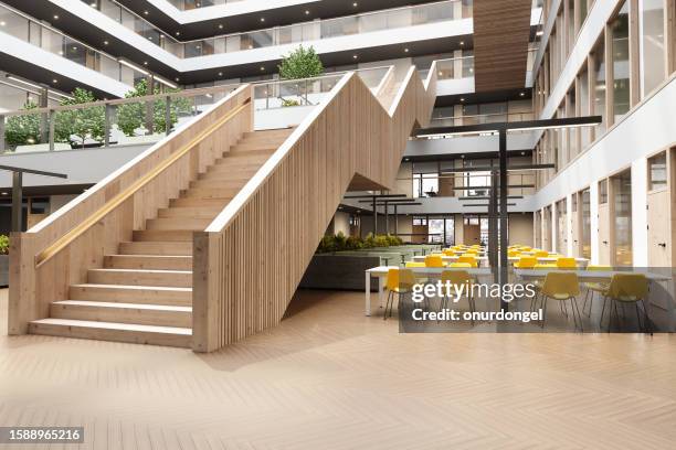 modern office or library interior with wooden staircase, plants and waiting area - cafeteria stockfoto's en -beelden