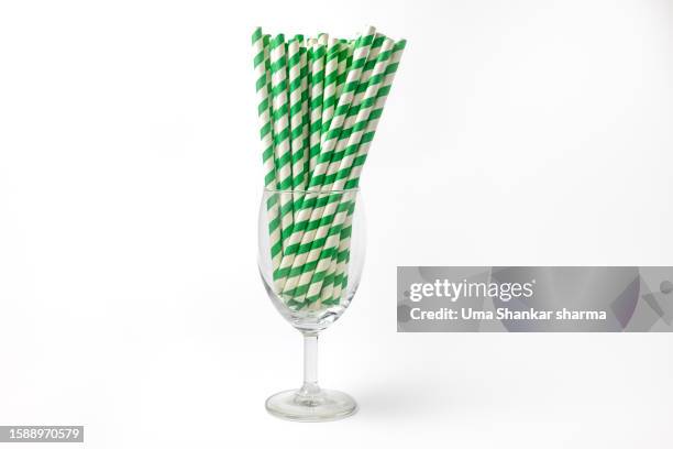 green striped paper straw on white background - belgium india stock pictures, royalty-free photos & images