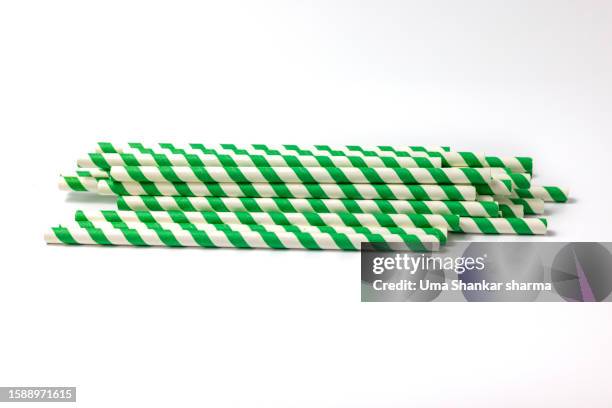 green striped paper straw on white background - belgium india stock pictures, royalty-free photos & images