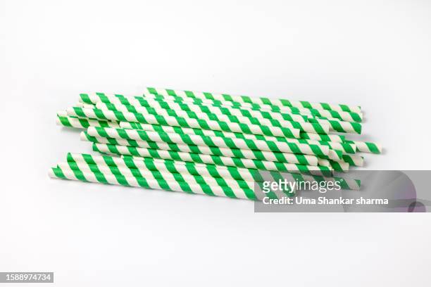 green striped paper straw on white background - belgium india stock pictures, royalty-free photos & images