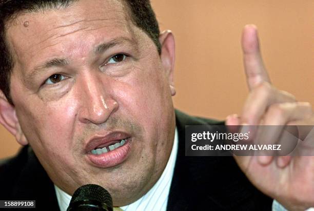 Venezuelan President Hugo Chavez answers questions during a press conference at the Presidential Palace in Caracas, 13 February 2004. Chavez...