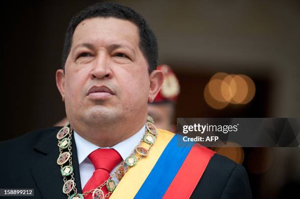 Venezuelan President Hugo Chavez, listens to the national anthem as he arrives at the Congress building in Caracas on January 15, 2011 to present the...