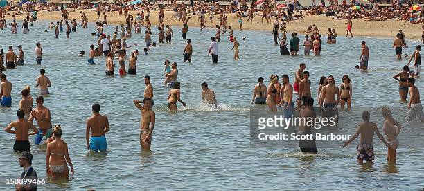 People swim in the water at St Kilda Beach on January 3, 2013 in Melbourne, Australia. Temperatures are expected to soar to above 40 degrees for...