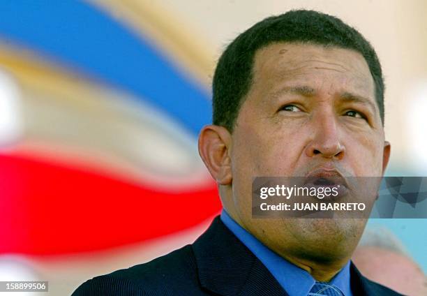 Venezuelan President Hugo Chavez sings the national anthem at the beginning of a military parade during the celebrations of the 83th anniversary of...