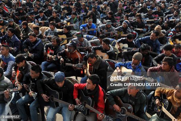 Musicians play John Lennon's "Imagine" in a memorial tribute to the 23-year old Indian gang rape victim, during a mass guitar ensemble played by some...