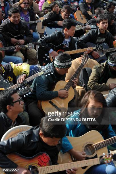 Musicians play John Lennon's "Imagine" in a memorial tribute to the 23-year old Indian gang rape victim, during a mass guitar ensemble played by some...