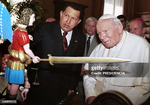 Pope Juan Pablo II is seen with Venezuelan President Hugo Chavez 12 October 2001 in the Vatican City, Italy. The Pope made a plea to solve the oil...