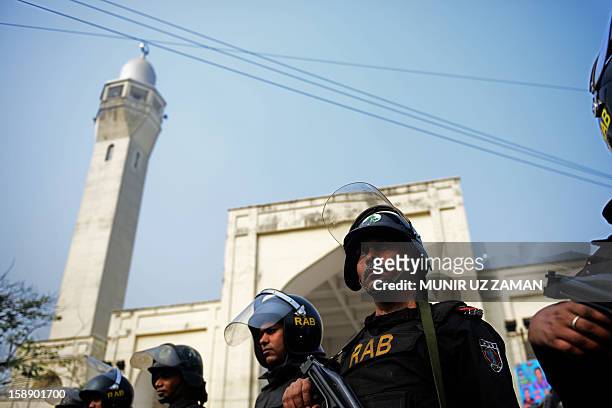 Bangladeshi Rapid Action Battalion personnel police look on from an armoured vehicle during a protest against Ahmadiyya Muslims in Dhaka on January...